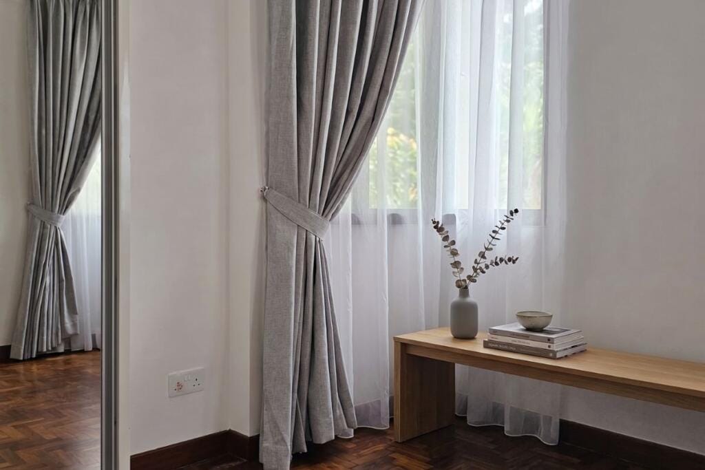 Day and blackout curtains in a Bishan condo bedroom, Singapore by Cornerstone