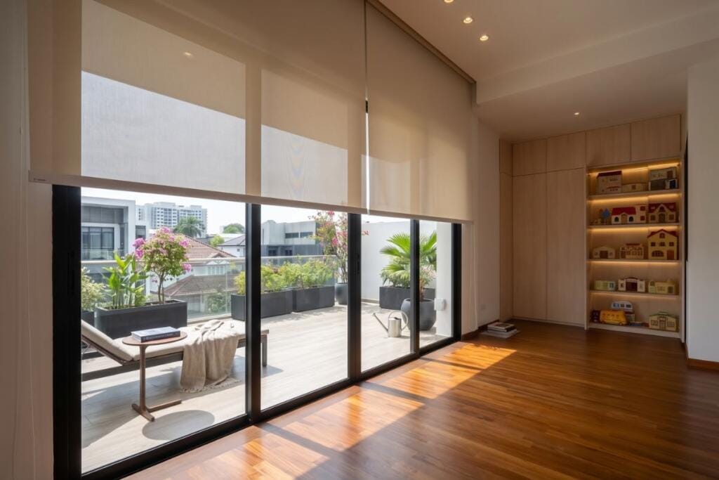 Sunscreen roller blinds filtering sunlight in a Bukit Timah home, Singapore by Cornerstone