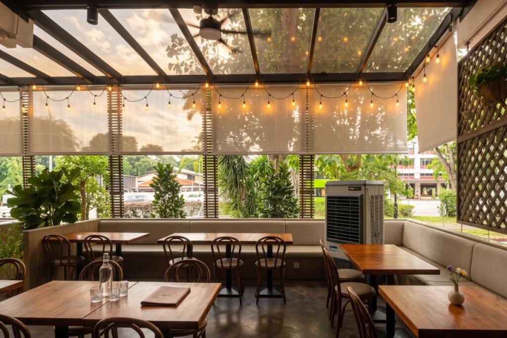 Sunscreen outdoor blinds providing shade for a cafe in Changi, Singapore by Cornerstone