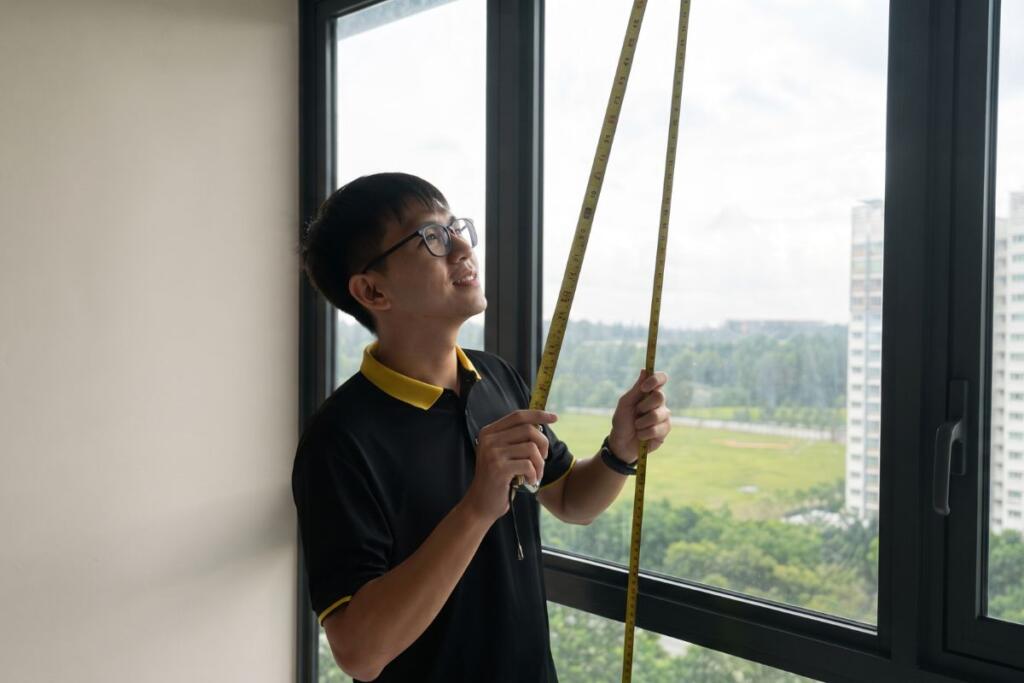 Window being measured for custom blinds in a Singapore home